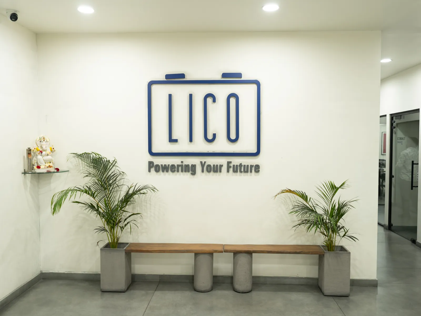 Reception wall with LICO logo, bench and planters — LICO
